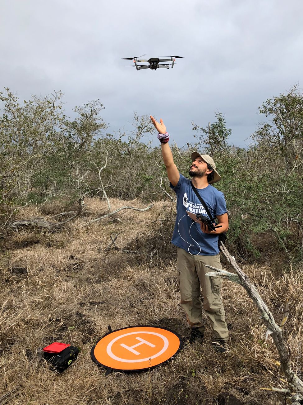 Francisco Laso hand-launching a mapping drone in dry scrubland