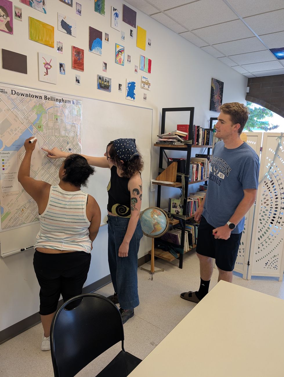 Community members adding notes to a printed campus accessibility map